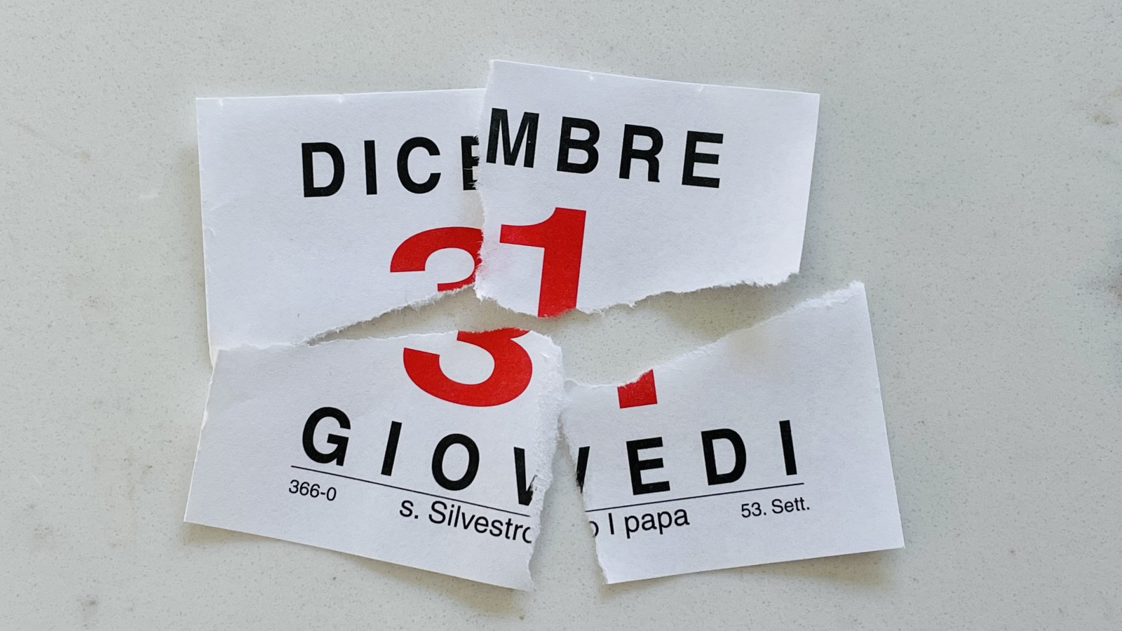 Torn-up calendar page for December 31