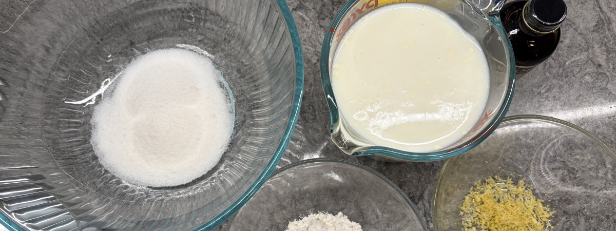 Mise en place for egg custard: sugar, egg yolks, milk, flour, lemon zest, vanilla extract